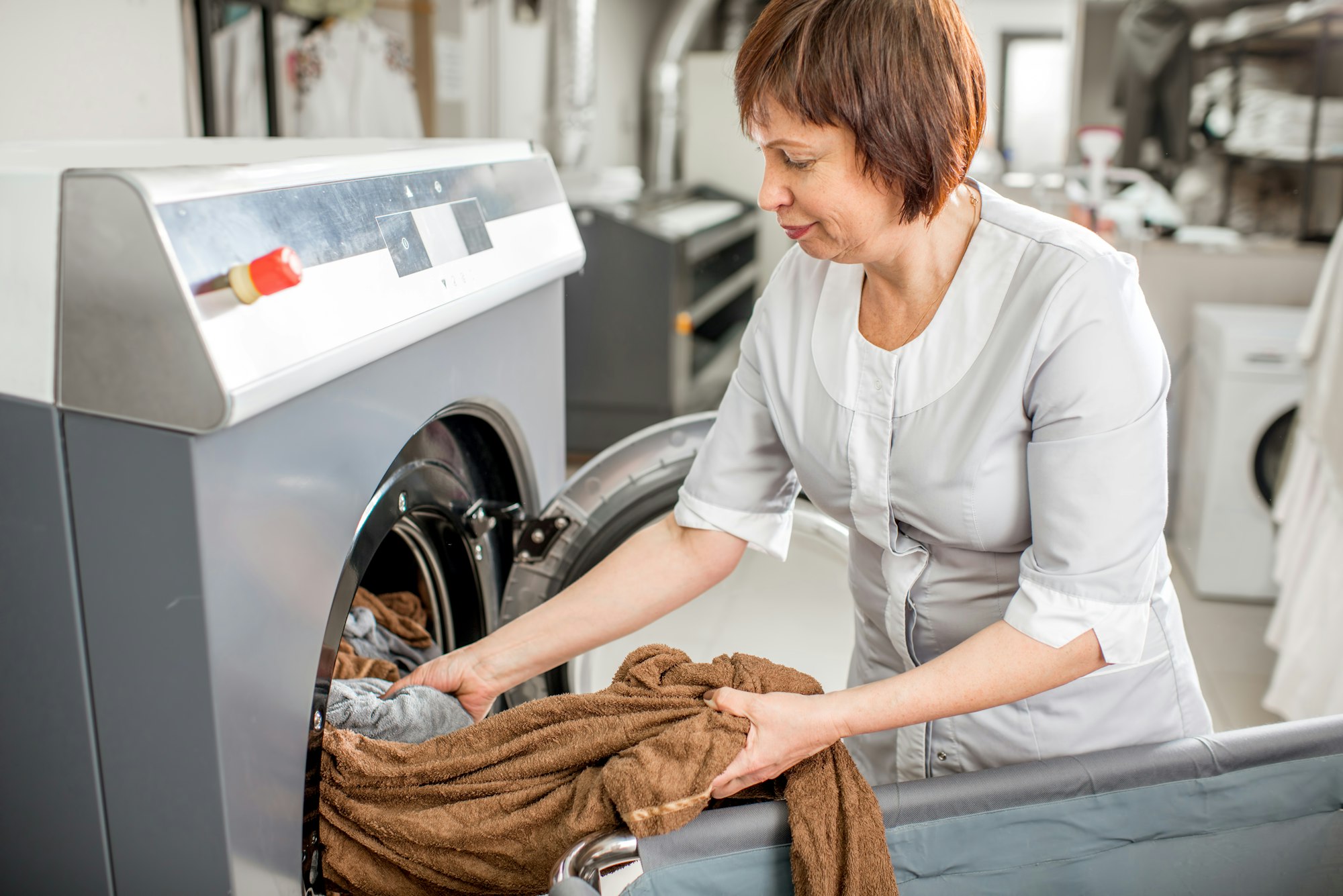 Senior washwoman in the laundry